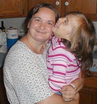 Mihaela and girl laughing in kitchen